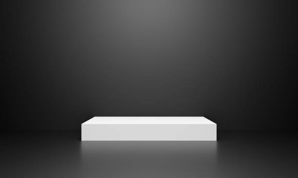 istock 3d exhibition stand. White blank empty podium on grey black background for presentation and exposition. Abstract 3d podium dark for mock up store. Pedestal for display product. Interior stage. 1212101205