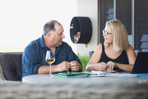 istock Middle Aged Couple Planning Holiday 1212103084