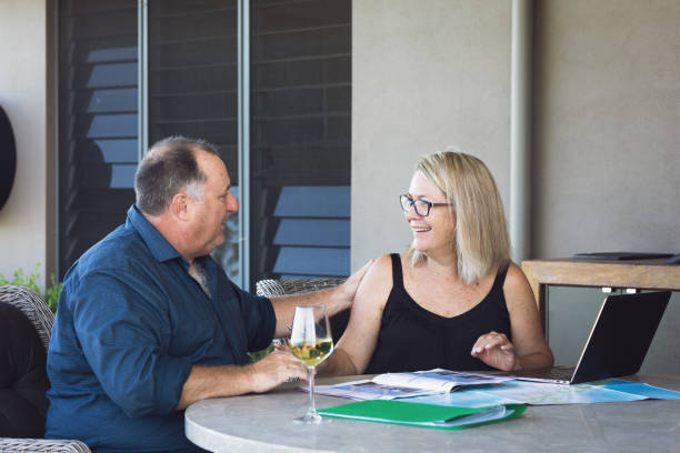 istock Middle Aged Couple Planning Holiday 1212103746