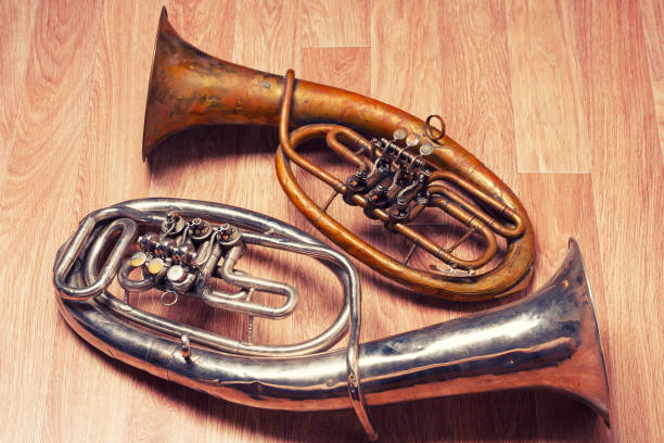 istock two old rusty alto saxhorn on wooden background 1212103847