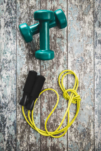 istock Green dumbbells and jump rope. 1212104817