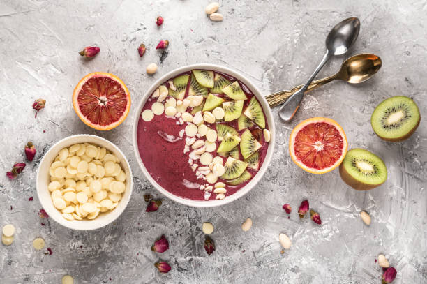 istock Healthy breakfast bowl: blueberry smoothie with kiwi, white chocolate and nuts 1212105892