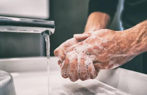 Photo of Coronavirus pandemic prevention wash hands with soap warm water and , rubbing nails and fingers washing frequently or using hand sanitizer gel