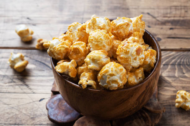 istock Popcorn in caramel glaze in wooden plates on a rustic table. Copy space. 1212106832