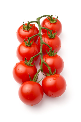 Eight fresh cherry tomatoes on the vine isolated on white. Soft shadow.