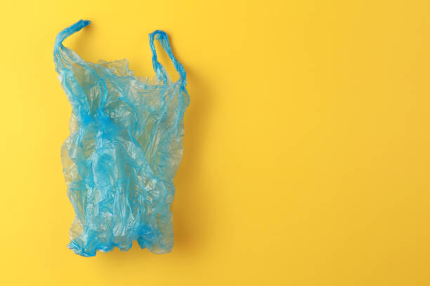 istock Used plastic bag on yellow background 1212107505