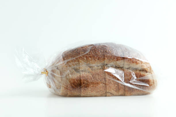 istock Close-up of sliced grain bread in a transparent plastic bag on white background 1212107571