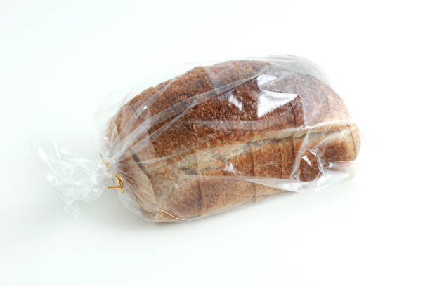 istock Close-up of sliced grain bread in a transparent plastic bag on white background 1212107576