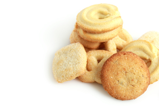 Traditional Danish butter cookies on white background.