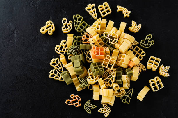 istock Raw Christmas pasta on a black concrete background. Cooking concept. Top view with copy space. 1212108583