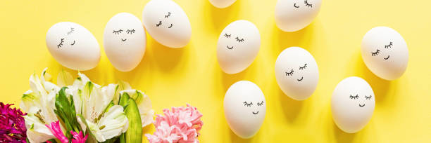 istock Creative easter eggs with cute face and sleepy eyes on pastel yellow background. Happy Easter concept. Flat lay, top view, mockup, template, overhead, copy space 1212118716