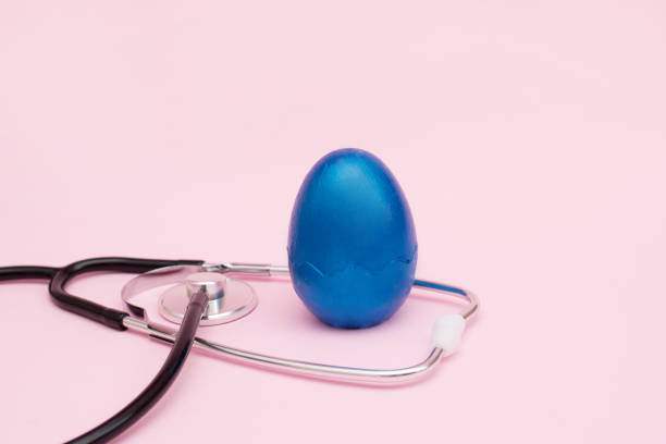 istock Stethoscope with classic blue egg on a pink background. copy space 1212127046