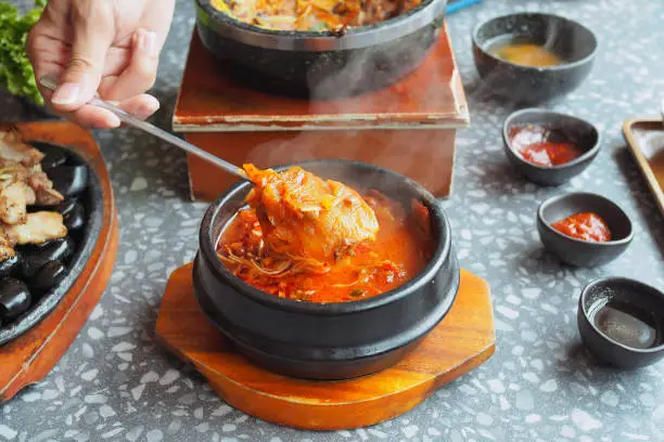 Photo of Kimchi soup served in hot pot; traditional Korean food.