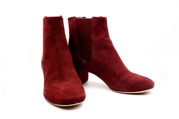 istock Burgundy red felt and leather boots 1212129045