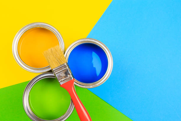 istock Metal paint cans and paint brushes on multicolor background. Top view. Copy space. 1212129346