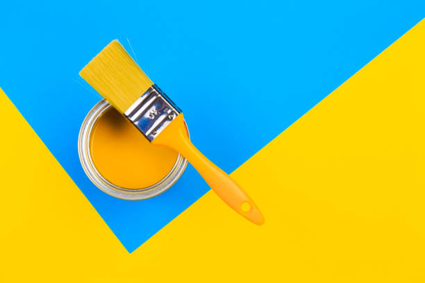 istock Yellow  Paint Can with Brush Top View On multicolor Background. 1212129446