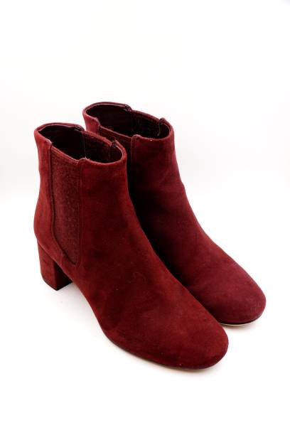 istock Burgundy red felt and leather boots 1212129453