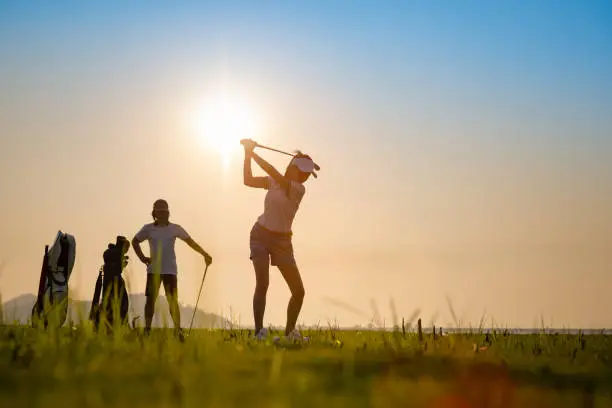 couple lover playing golf together in the course, try to keep golf ball away from the rough to fairway, difficult time stay together in the family concept
