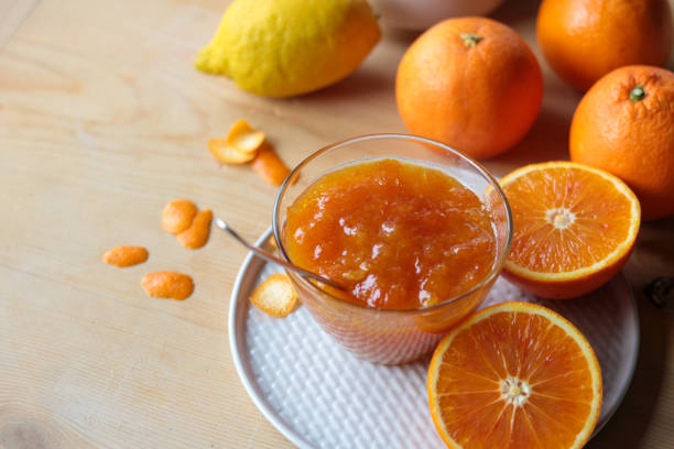 istock orange marmalade in a glass bowl and fresh oranges 1212135843