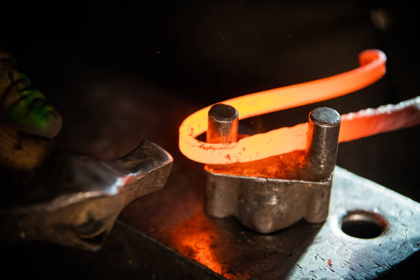 istock A blacksmith making a unique handle for the knife - bending the metal 1212135991