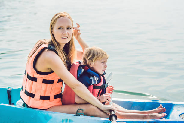 istock Mother and son kayaking at tropical ocean. 1212138907