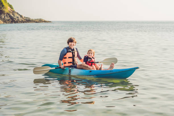 istock Father and son kayaking at tropical ocean. 1212138951