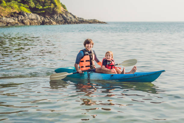 istock Father and son kayaking at tropical ocean. 1212138954