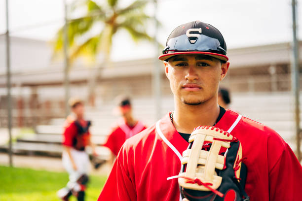 istock Hispanic baseball player standing outdoors with glove 1212139011