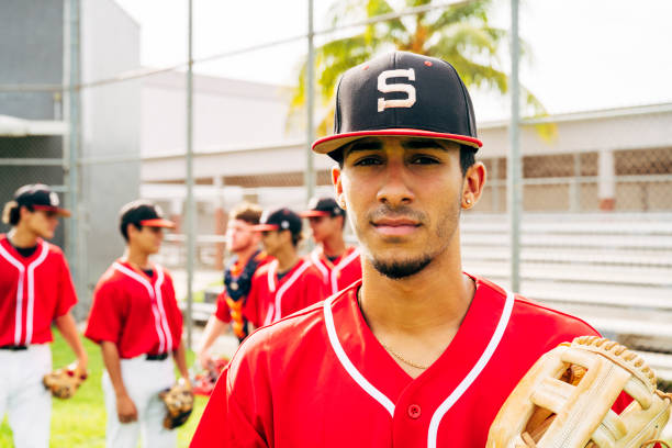 istock Young Hispanic baseball player standing outdoors with glove 1212139015