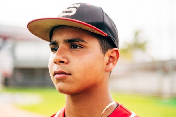 istock Portrait of young Hispanic baseball player looking away 1212139018