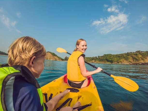 istock Mother and son kayaking at tropical ocean 1212140990