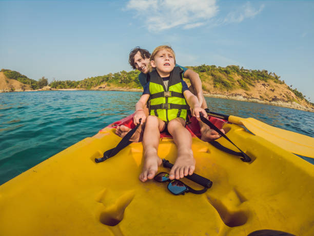 istock Father and son kayaking at tropical ocean 1212140993