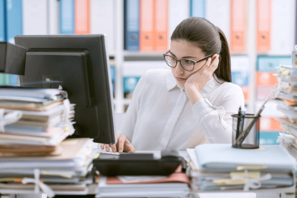istock Bored office worker sitting at desk 1212141456