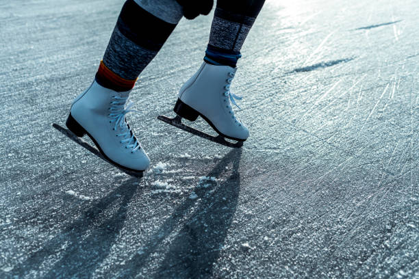istock A female legs with ice skates on ice surface 1212141612