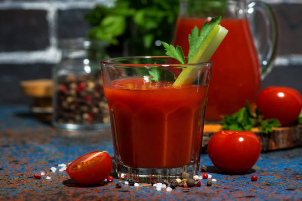 istock fresh tomato juice with salt and celery on dark table 1212142512