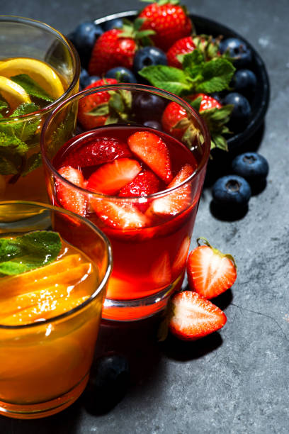 istock fresh fruit lemonades in assortment on dark background, top view vertical 1212142585