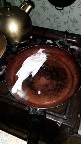 istock Gutting and frying river roach the  fish 1212143089