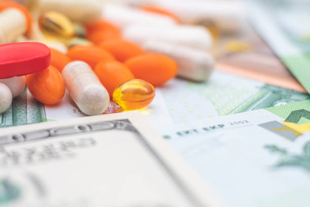 istock pills and money. 1212145649