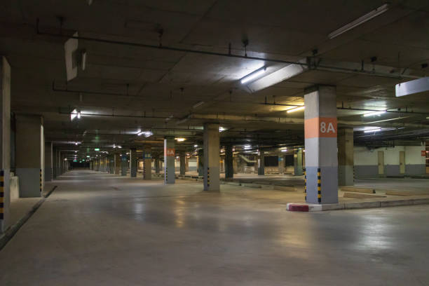 istock Empty parking interior at night. Parking garage at eight floor. 1212147313
