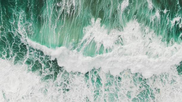 istock huge turquoise ocean waves on foamy surface aerial view 1212148636