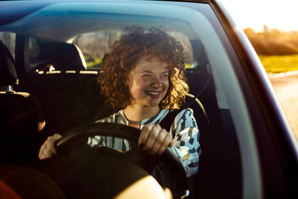 istock Young woman driving car 1212148754
