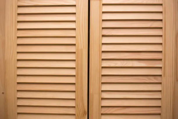 Wooden blinds surface. Striped timber doors. Vintage home design.