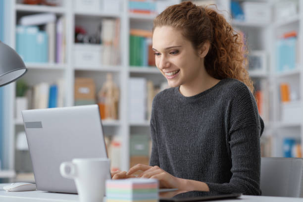 istock Young woman connecting with her laptop 1212153558