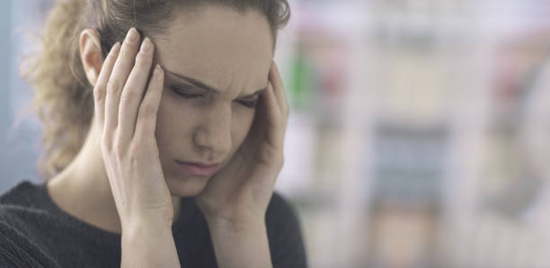 istock Young woman with headache 1212153601
