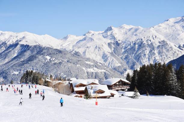 istock Ski resort with snowy mountains and skiers 1212155346
