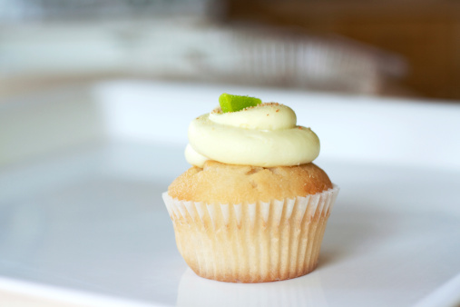 One Key Lime Pie Cupcake on a white tray.
