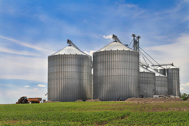 istock Group of very large steel silos with tractor pulling away 121215977