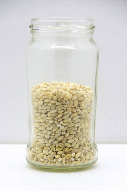 istock Glass jar with barley on a white background, side view 1212159872