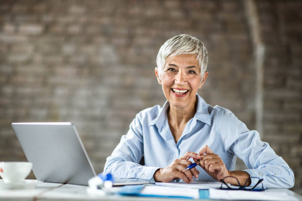 istock Happy senior entrepreneur working in the office. 1212160218