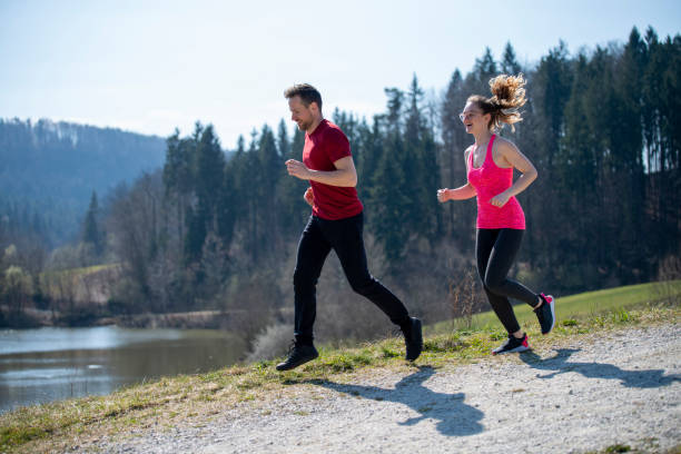 istock Young couple running on a sunny day 1212160528